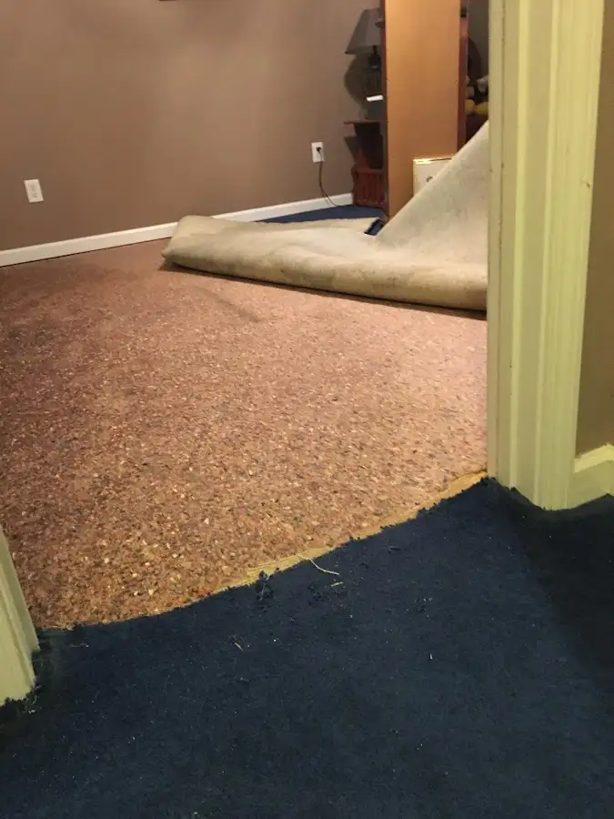 Carpet pad removal revealing water damage during Drying & Dehumidification in Arkansas City